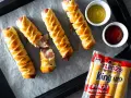 Salchichas con hojaldre doradas y crujientes, listas para mojar en kétchup y mostaza. ¡Un bocado delicioso!