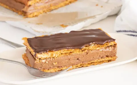 Delicioso milhojas de chocolate con capas crujientes de hojaldre y crema de cacao.