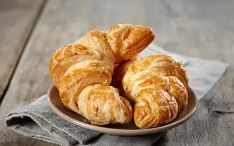 Croissants dorados y hojaldrados, perfectos para tu receta de croissant mantequilla. Un placer crujiente.