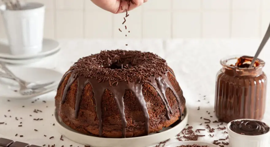 Bizcocho de chocolate con cobertura y chispas, listo para disfrutar.