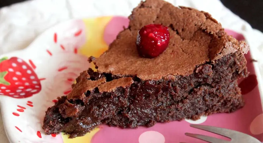 Deliciosa tarta sin gluten y sin lactosa, con un centro fundente y coronada con una frambuesa.