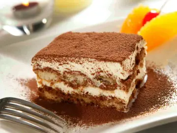 Delicioso tiramisú con mascarpone, espolvoreado con cacao. Una porción perfecta para disfrutar de esta clásica receta italiana.